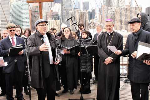 Christians cross bridge on solemn Good Friday